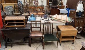 An oak gateleg dining table with barley twist legs together with a stool, two chairs,