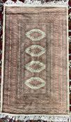 A silk and wool blend rug / wall hanging with a red ground and four medallions and multiple guard