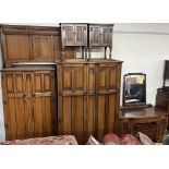 A 20th century oak bedroom suite comprising a double wardrobe, single wardrobe, dressing table,