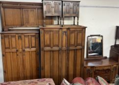 A 20th century oak bedroom suite comprising a double wardrobe, single wardrobe, dressing table,