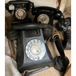 Three black bakelite telephones and additional handsets