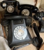 Three black bakelite telephones and additional handsets