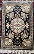 An Iranian rug / wall hanging with a black ground and central medallion,