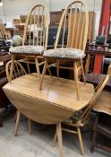 A beech and elm Ercol drop leaf dining table and four chairs