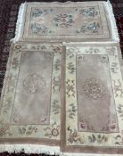 A pair of Chinese rugs with a pink ground and central roundel 151 x 90cm together with another