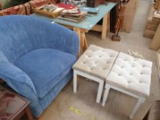 An upholstered tub chair in blue together with a pair of upholstered dressing table stools