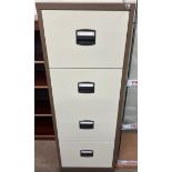 A four drawer filing cabinet in brown and cream