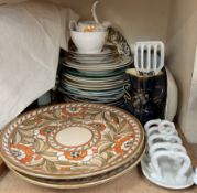 A pair of Charlotte Rhead pottery chargers decorated with flowers and leaves together with various