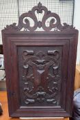 A carved hardwood hanging corner cupboard