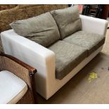 An upholstered two seater settee with silver cushions