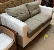 An upholstered two seater settee with silver cushions