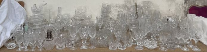 A large collection of crystal drinking glasses, bowls,