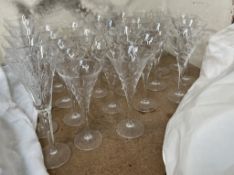 Waterford crystal champagne glasses together with a suite of glasses
