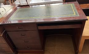 A reproduction mahogany desk, with a leather inset top,