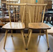 A pair of mid 20th century stick back dining chairs on turned legs