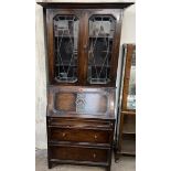 A 20th century oak bureau bookcase, with a moulded cornice and glazed doors,