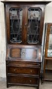 A 20th century oak bureau bookcase, with a moulded cornice and glazed doors,