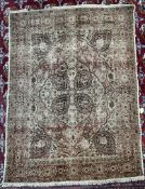 A Persian rug with a cream ground,