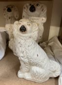 Three Staffordshire dogs with gilt padlock and chain