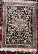 A Persian rug / wall hanging with a black ground,