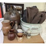 A studio pottery vase of large form together with pottery mugs, a foot bath,