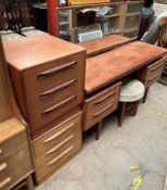 A G-Plan teak dressing table together with a dressing table stool and a pair of teak bedside