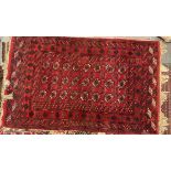 A red ground Turkoman rug with multiple guls to a red ground,