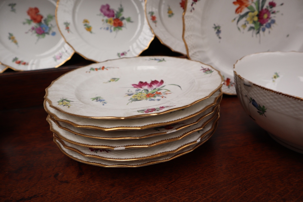 A 19th century Copenhagen porcelain part dinner set painted with garden flowers to a basket weave - Image 11 of 19