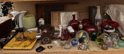 A collection of glass paperweights together with cranberry glass, a Bell & Howell model 605 camera,