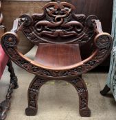 A continental X frame chair, carved with dragons,