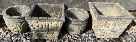 A pair of circular reconstituted stone planters together with a pair of square examples