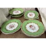 A 19th century English part dessert service painted with flowers to an apple green border