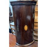 A reproduction mahogany hanging corner cupboard with shell inlay,