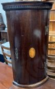 A reproduction mahogany hanging corner cupboard with shell inlay,