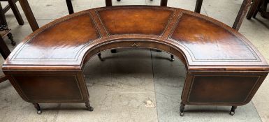 A reproduction mahogany half moon occasional table with a leather inset top and drop flaps on