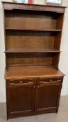 A 20th century oak dresser, with a planked back and two shelves,
