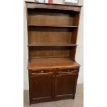 A 20th century oak dresser, with a planked back and two shelves,