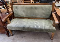 A modern bench seat with pad upholstered seat and back on turned legs