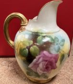 A Royal Worcester flat back jug, decorated with pink and yellow roses,