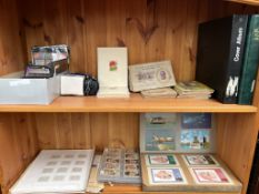 A collection of cigarette cards, postcards,