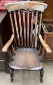 A 19th kitchen slat back chair on turned legs