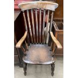 A 19th kitchen slat back chair on turned legs