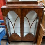 A 20th century walnut display cabinet with glazed doors and side on cabriole legs and pad feet