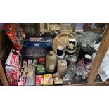 A stoneware foot warmer together with drinking glasses, pottery mugs, board games, cribbage board,