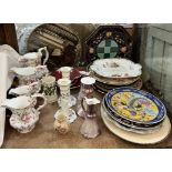 A set of four graduated floral decorated jugs together with assorted plates,