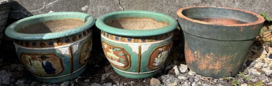 A pair of pottery jardinieres decorated with figures together with a terracotta planter