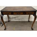 A 20th century walnut side table of rectangular form with rounded corners above three drawers on