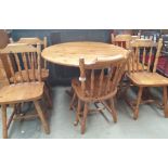 A 20th century pine supper table together with a set of five pine dining chairs