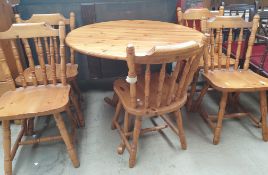 A 20th century pine supper table together with a set of five pine dining chairs
