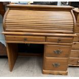 A 20th century pine tambour fronted roll top desk,